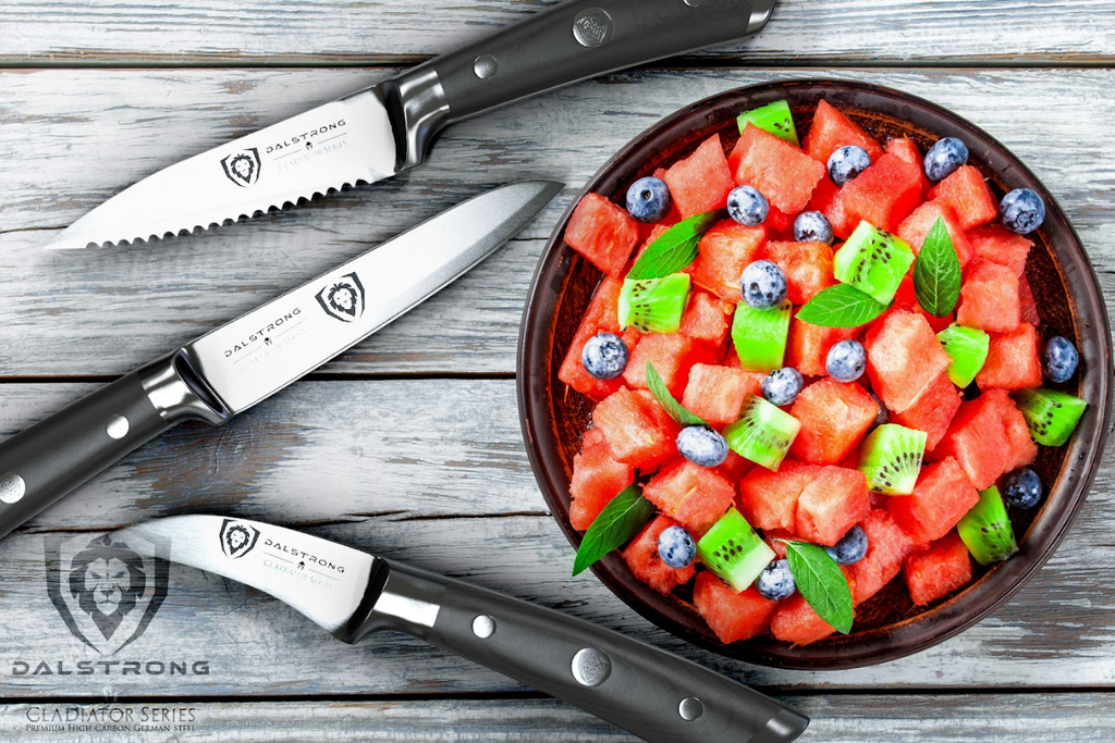 A photo of the 3-Piece Paring Knife Set Gladiator Series | NSF Certified | Dalstrong with a watermelon cut in cubes in a bowl