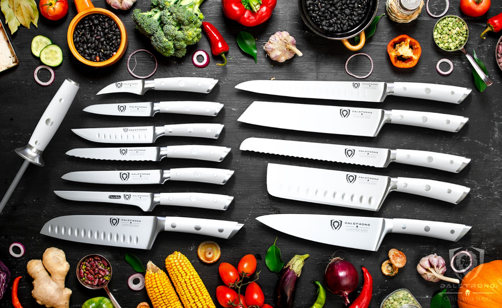 A photo of the 18-piece Colossal Knife Set with Block White Handles | Gladiator Series | Knives NSF Certified | Dalstrong with herbs and vegetables.