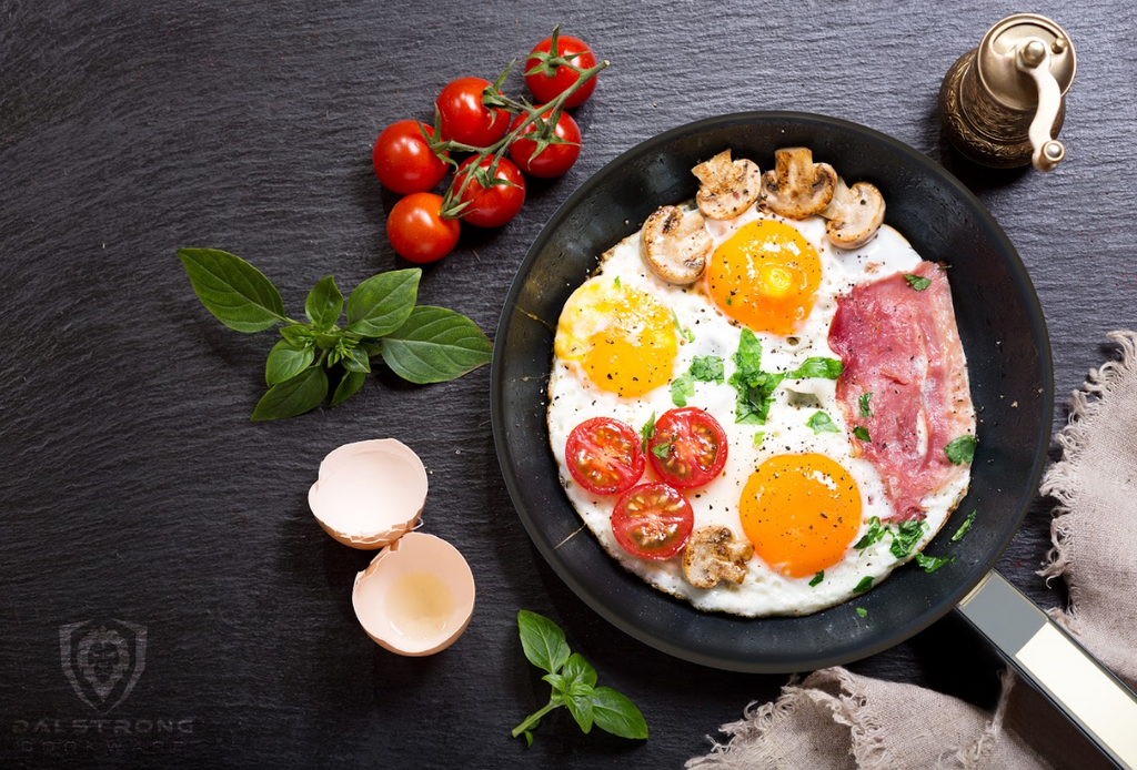 A photo of the 9" Frying Pan & Skillet ETERNA Non-stick Oberon Series Dalstrong with  eggs, bacon, tomatoes and mushroom.