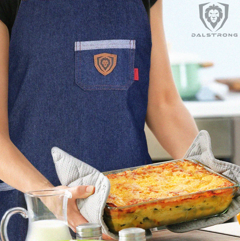 A man using Dalstrong Professional Chef's Kitchen Apron - American Legend holding a mac and cheese