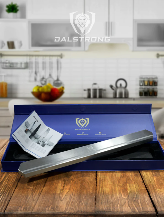 A photo of the Dalstrong Magnetic Bar Stainless Wall Knife Holder on top of a wooden table