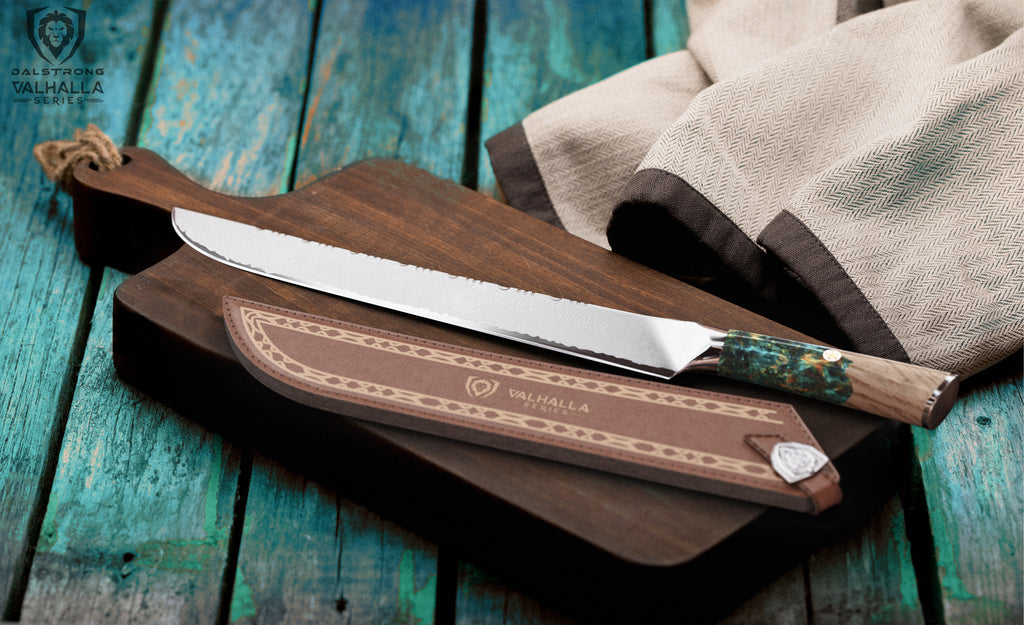 Dalstrong Shogun Series Valhalla Slicer beside its leather knife sheath on a wooden cutting board