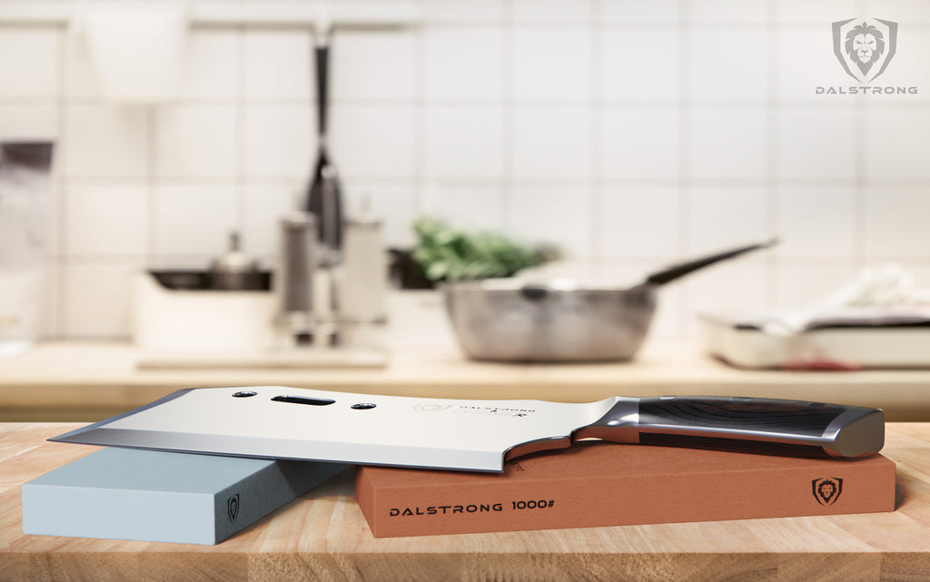 Dalstrong Gladiator Series Cleaver rests on a whetstone in a clean kitchen