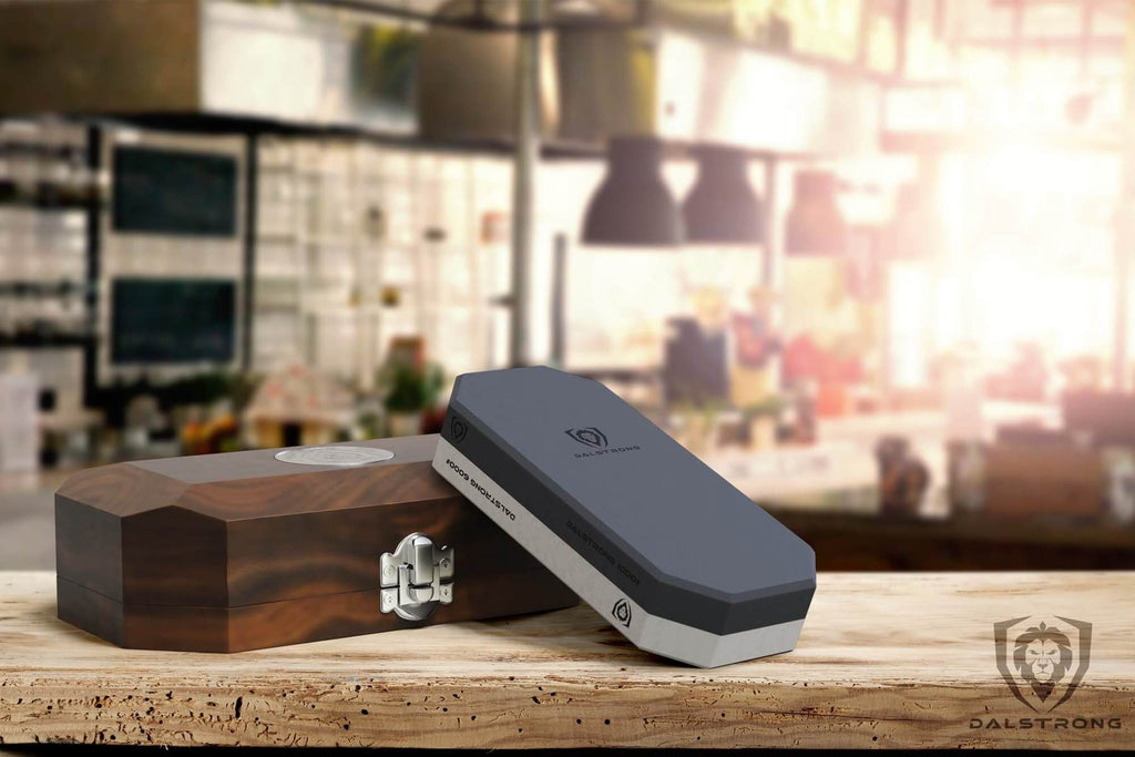 A small whetstone kit rests against an oak storage box with the sun shining in the background