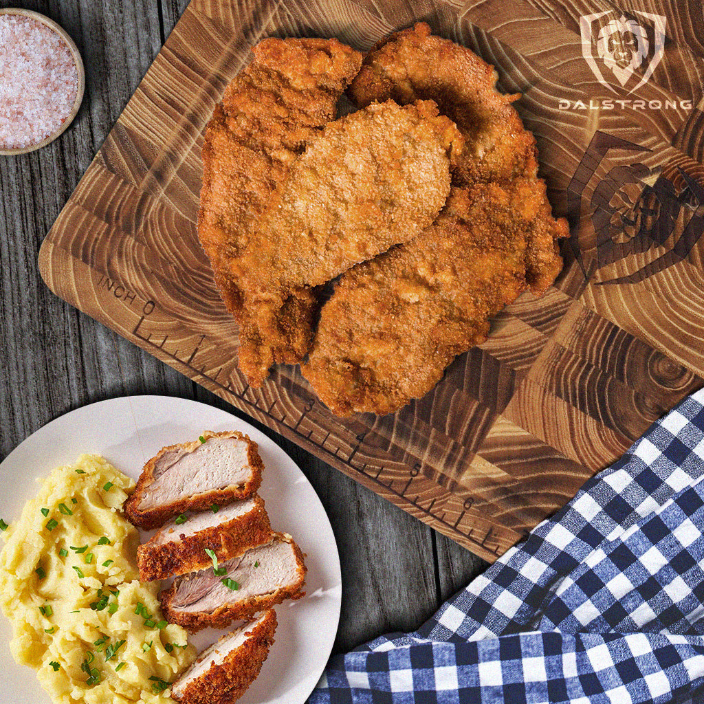 Breaded pork chops on a Dalstrong cutting board