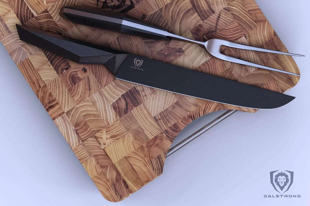 Carving Knife & Fork Set placed on a Dalstrong teak board with white backdrop