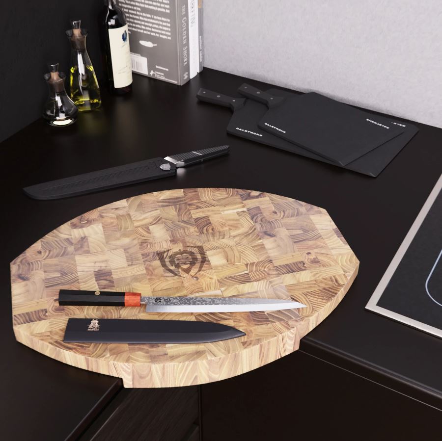 Dalstrong Corner Cutting Board displayed on a sleek black counter top surrounded with different knives