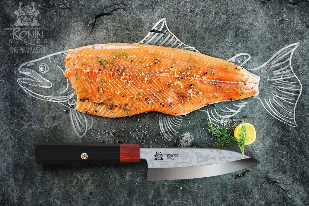 Dalstrong 6" Deba Knife beside a fish filet