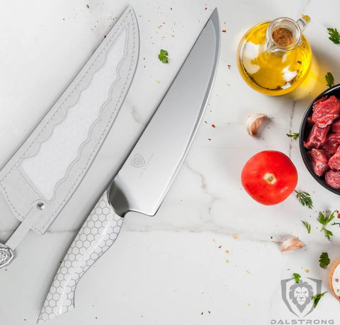 Dalstrong Frost Fire Series Chef knife on a marble counter top next to its white leather sheath.