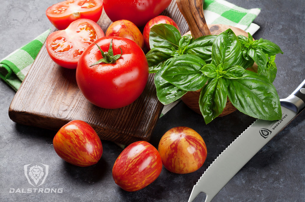 Tomatoes on a wooden cutting board beside the Gladiator Series Serrated Tomato Knife