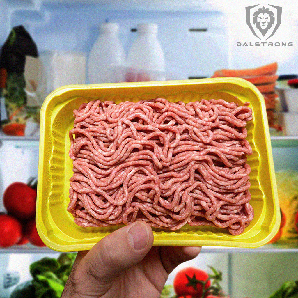 Man holding yellow package of raw ground beef in front of open fridge