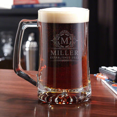 A tall beer mug filled to the rim with brown ale