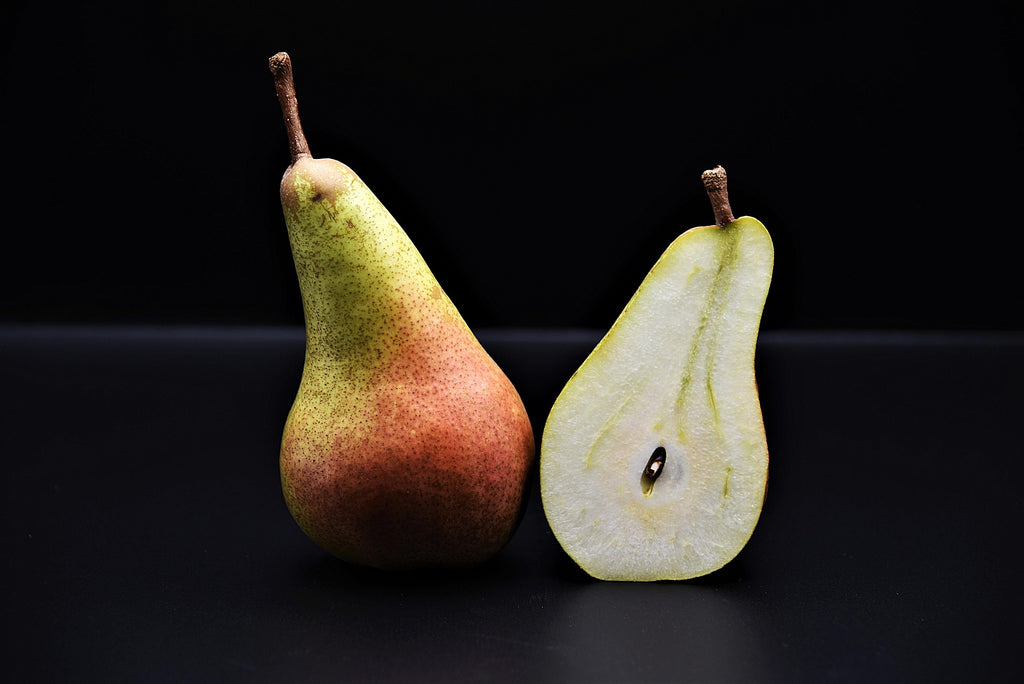 A photo of a pear sliced in half.