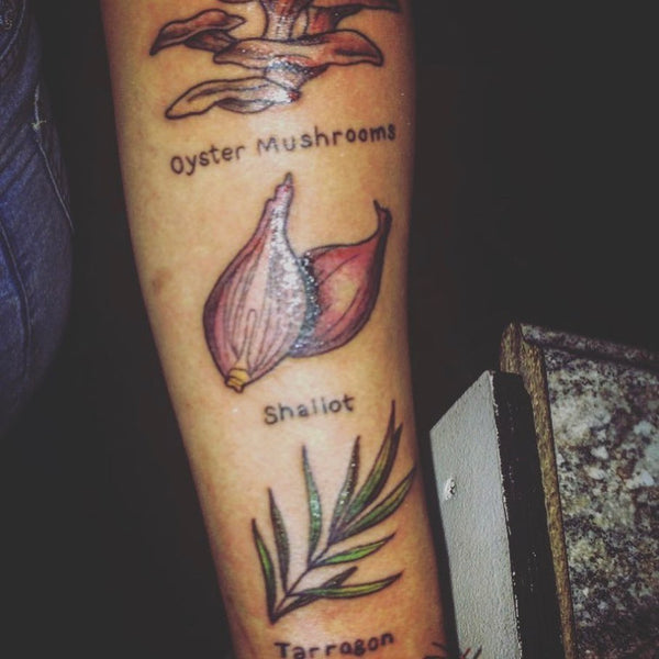 A tattoo with images and titles for mushrooms onion shallots and tarrogan