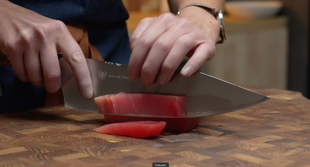 A woman slicing fish meat using the Dalstrong Valhalla Series Chef's Knife 8"