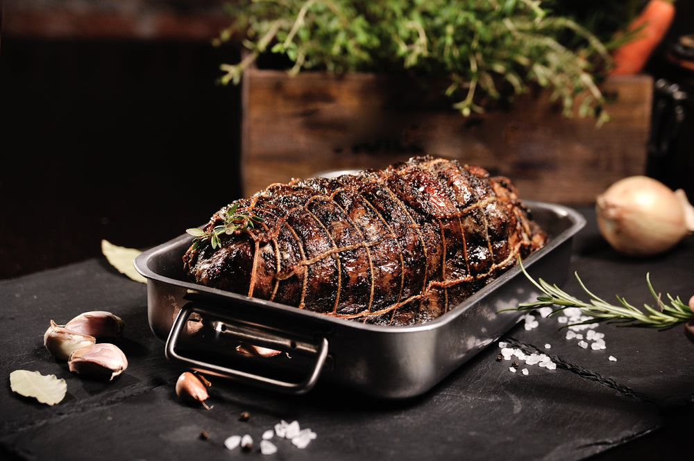 roasting pan with roast sitting on table