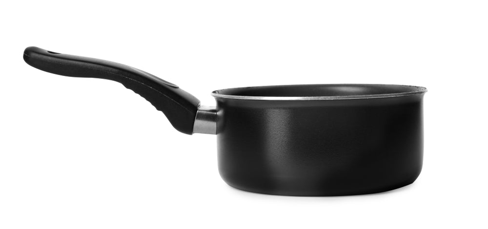 A black saucepan against a white background