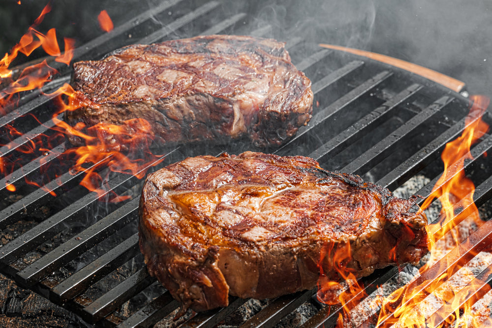 grilling steaks on a bbq grill