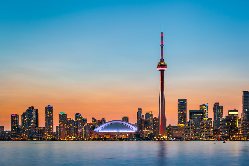Toronto night skyline over lake Ontario