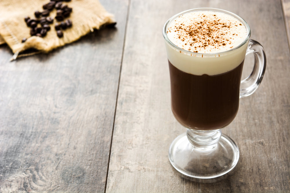 Irish coffee in glass on wooden table