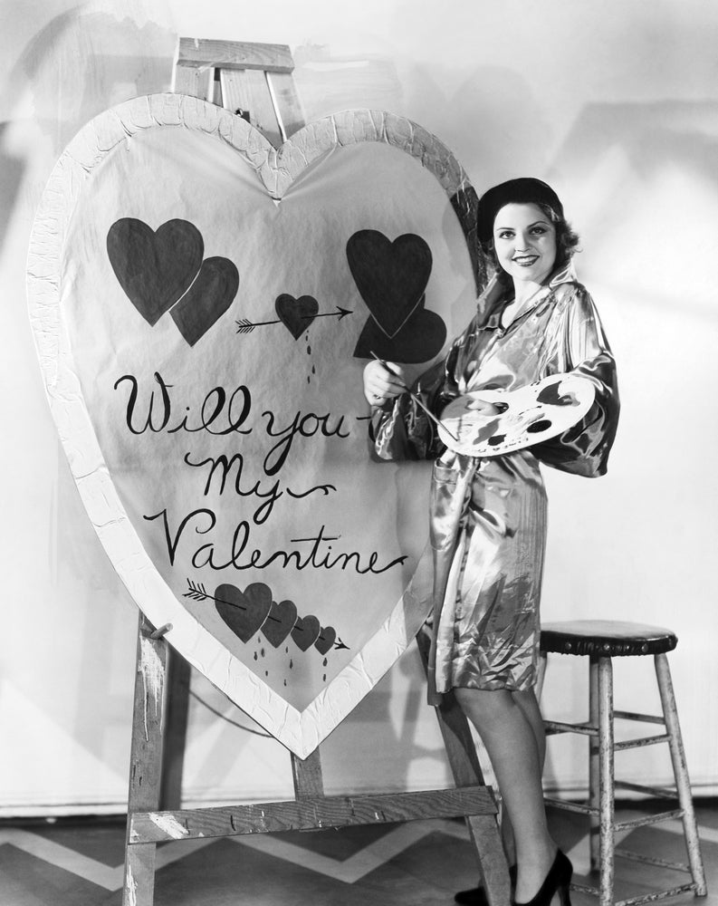 Classic black and white image of woman painting a valentine's day gift for her partner