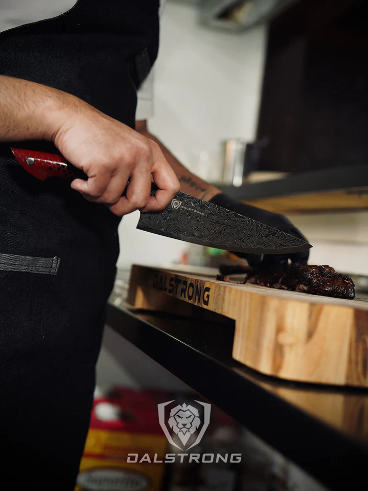 A man slicing meat on the Teak Cutting Board Lionswood Colossal.