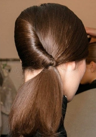 The reversed French twist pony is another one of the easy hairstyles for work on our list. 
