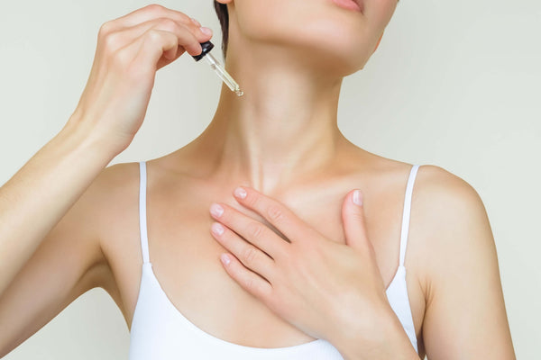 Applying face oil to neck