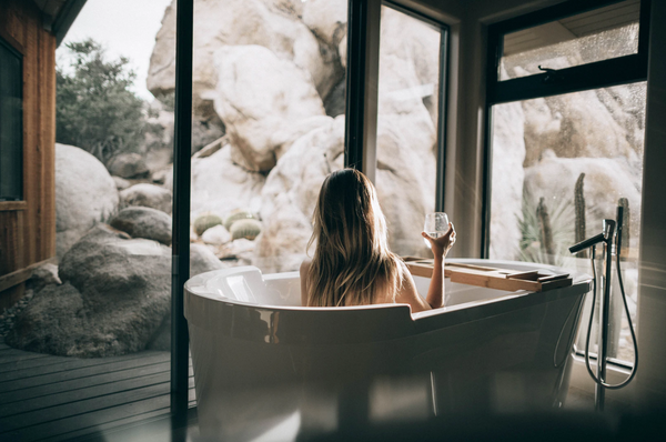 Woman in bath with wine