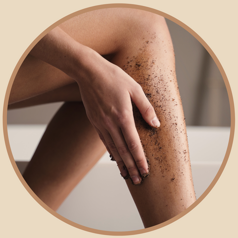 Crop shot of woman scrubbing legs with coffee scrub