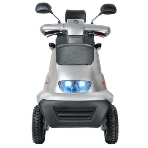 Image of a red 4-wheel mobility scooter, the AFIKIM Afiscooter S, seen from the front. The scooter is parked on a paved surface, showcasing its sleek design and comfortable seating.