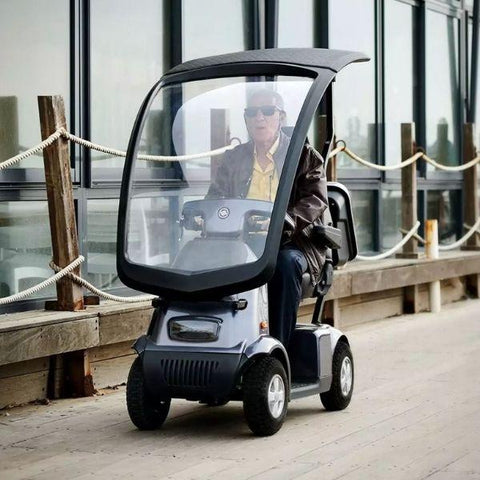 A man riding an Afiscooter C4 electric mobility scooter.