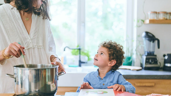 A Mom is cooking with boy. Toddler birthday parties ideas.