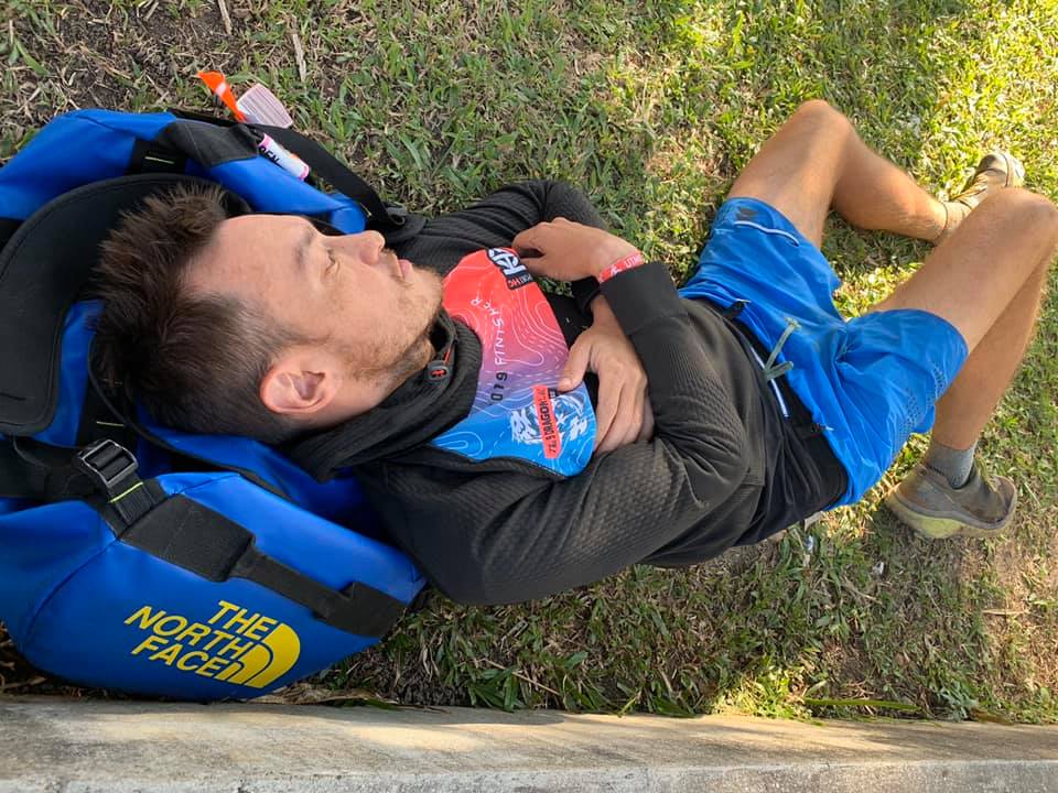 John Ellis sleeping at the finish line of Ultra Trail Panoramic in 2019