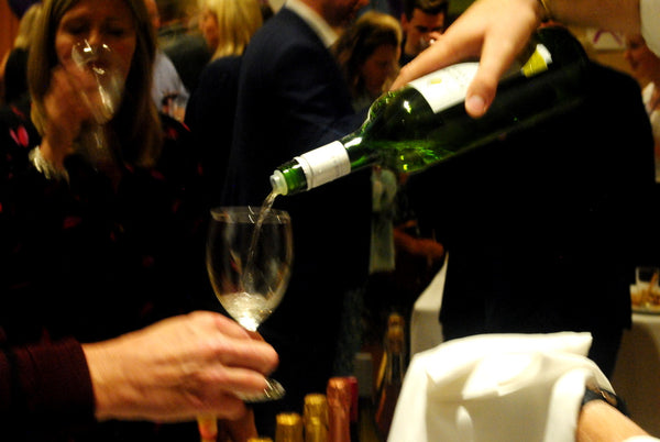 Pouring white wine at the Novel Wines launch party