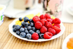 White plate of berry fruits