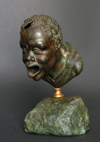 A Roman Bronze Oil Lamp Head of a Nubian