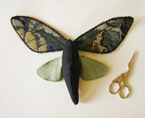 finished upper wings, body, underwings placed in the moth shape with embroidery scissors to the right