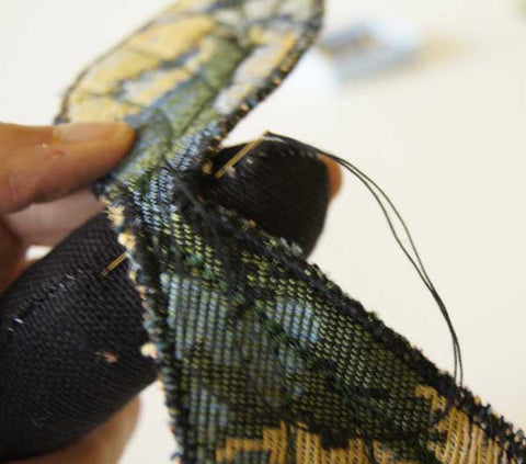 close up of whip stitchon upper edge of upper wings