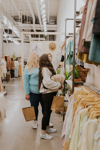 group of women looking at different clothing items