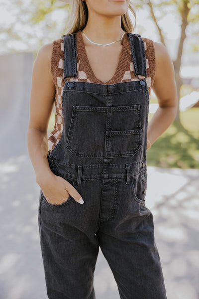 model wearing a sweater vest with overalls