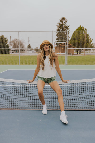 Model resting on tennis net