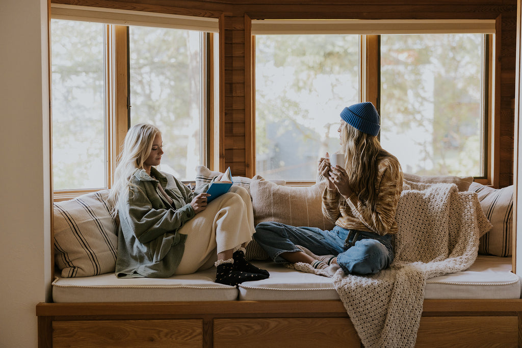 two women sitting together in a cabin