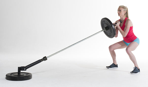 woman lifts up heavy bar with weights on one end