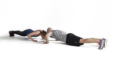 couple face each other dropping down into a pushup