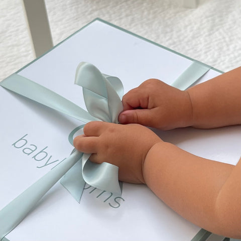Baby opening ribbon on perfectly packaged Babyblooms gift box
