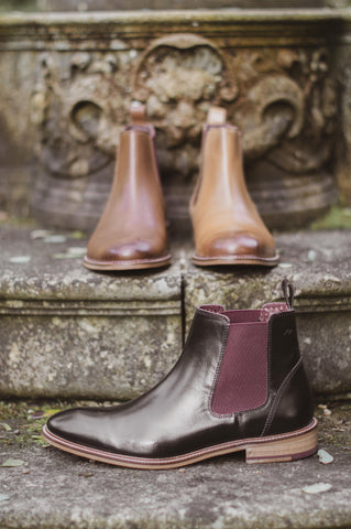 three shoes on some gothic stones steps, each a different coloured version of the same leather hamilton chelsea boot