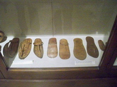 A display case in a museum with ancient Flip-flops