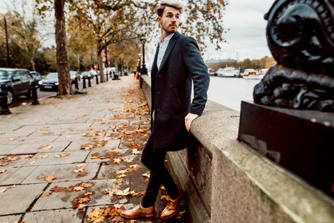 Man in wool coat and smart shirt with dark chinos and shelby oxford london brogue shoes in tan and tweed