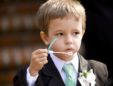 Page boy with bubbles in suit